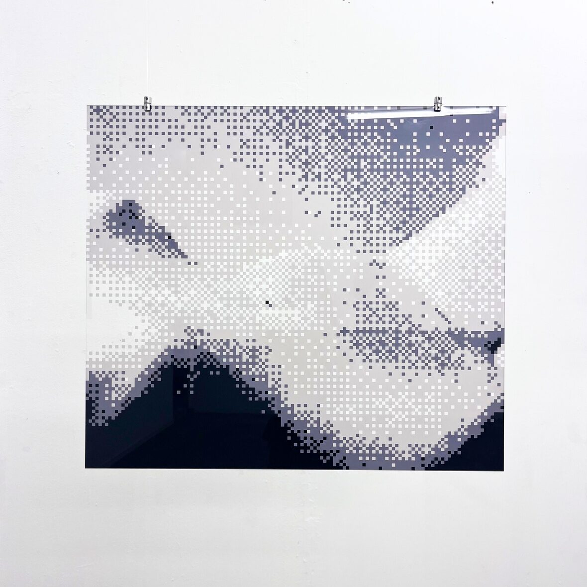 Pixelated monochrome photograph of a reclining nude figure