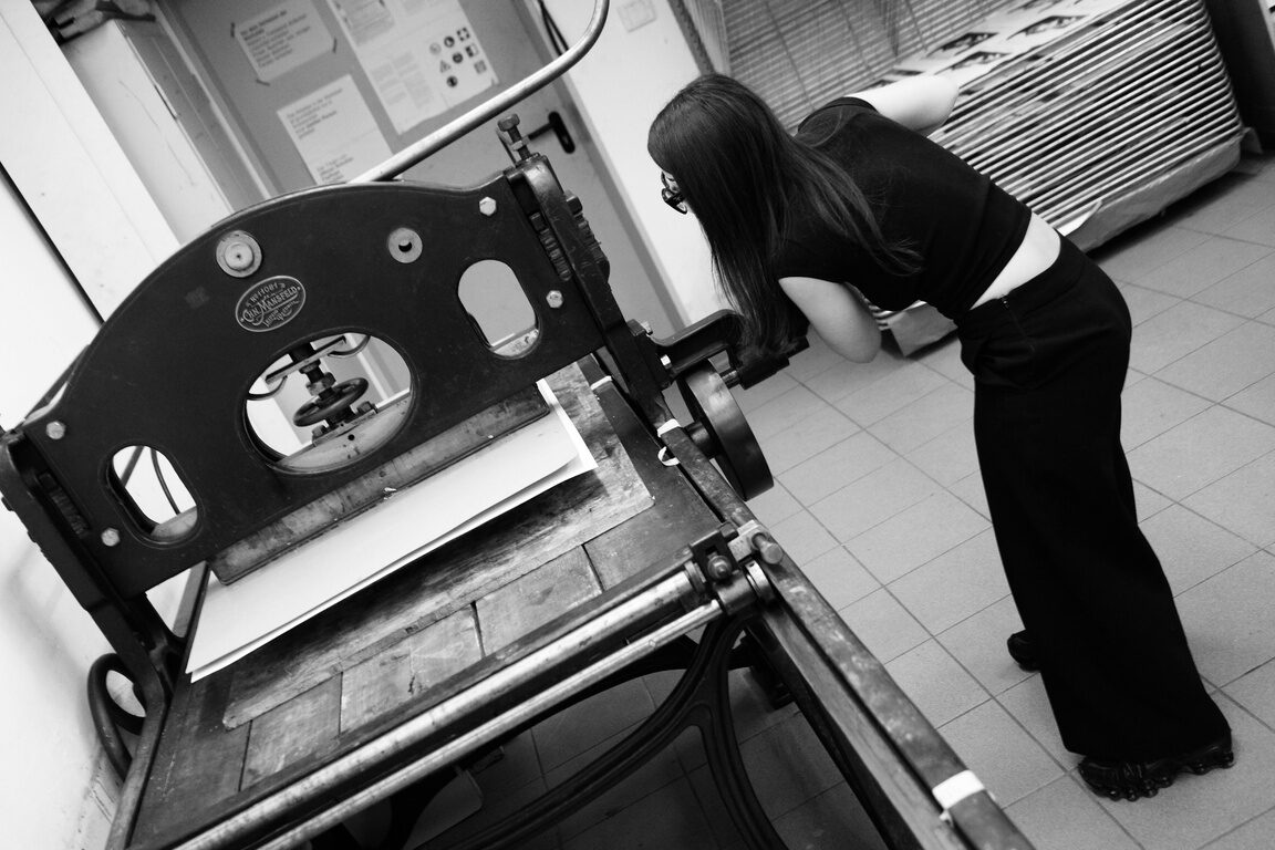Artist working at a lithography press